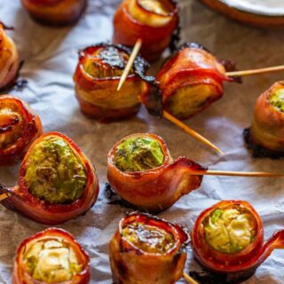 Brussels sprouts wrapped in bacon and served with dip