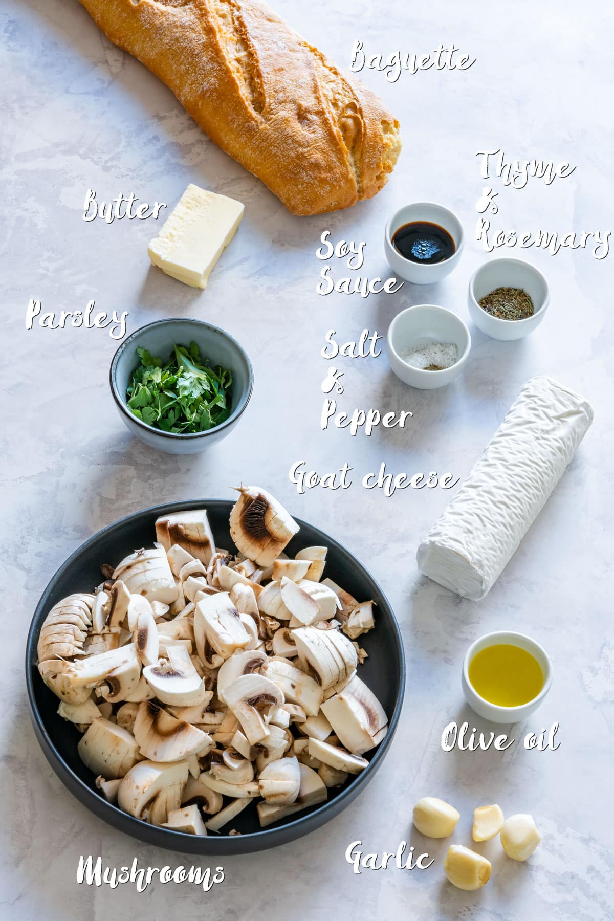 Ingredients for mushroom crostini: mushrooms, baguette, goat cheese, garlic and herbs.