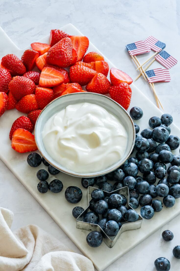 Yogurt fruit dip with strawberries and blueberries.