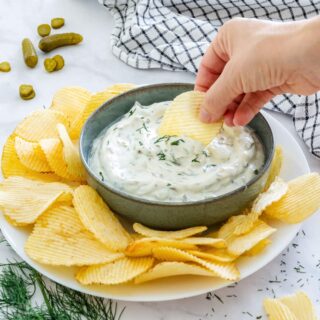 Dipping crinkle cut potato chips to homemade dill pickle dip.