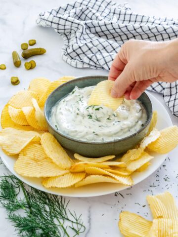 Dipping crinkle cut potato chips to homemade dill pickle dip.