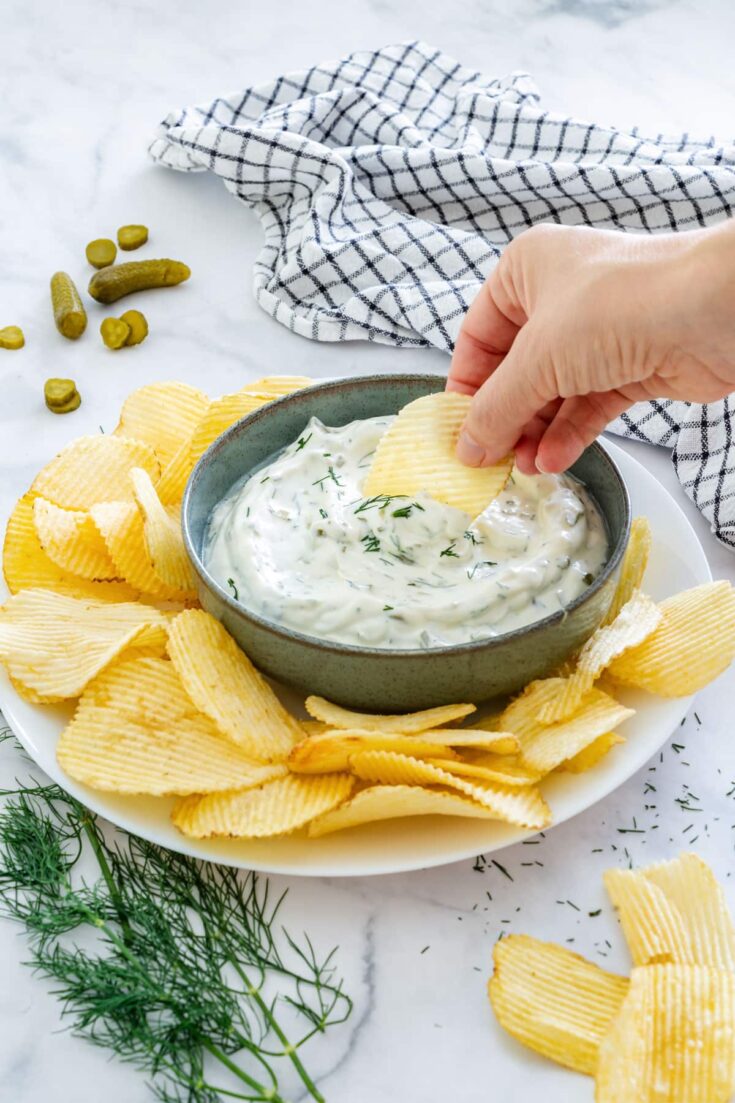 Dipping crinkle cut potato chips to homemade dill pickle dip.