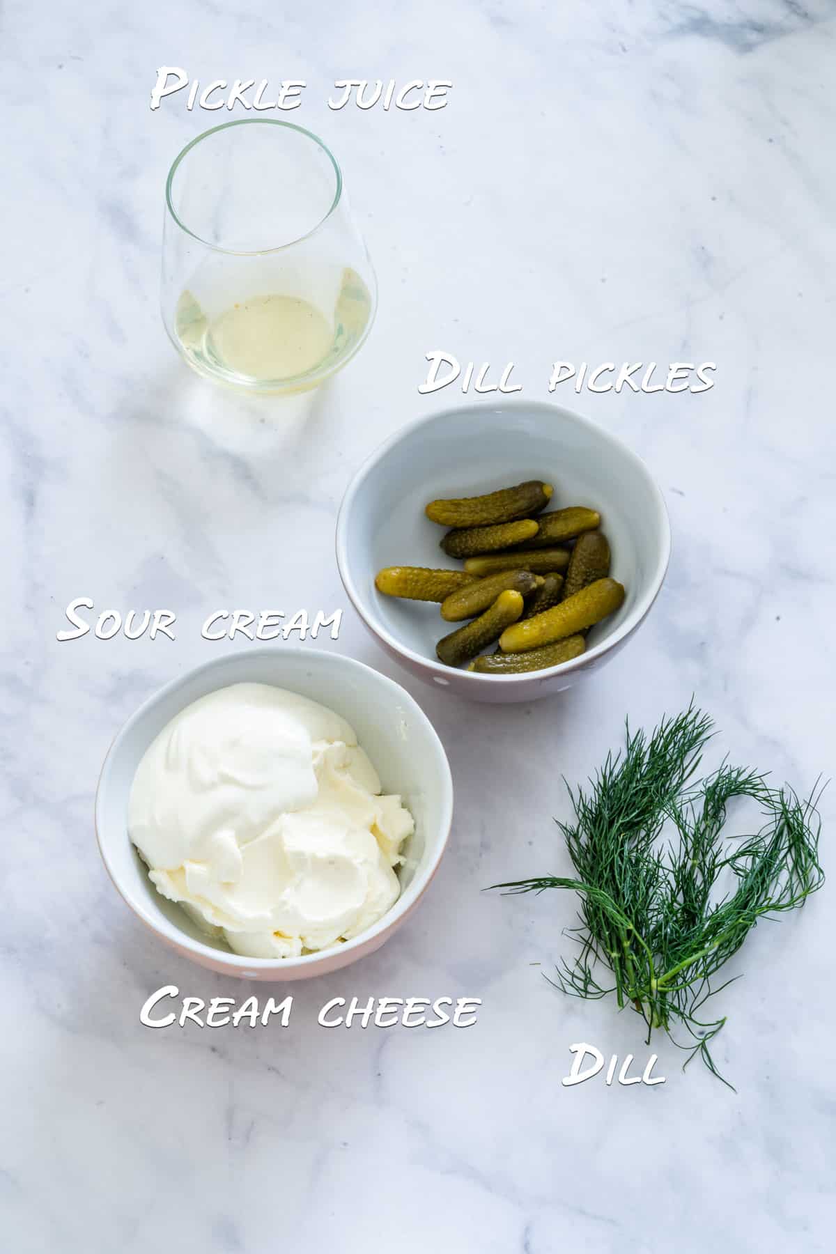 Ingredients of dill pickle dip: cream cheese, sour cream, dill, dill pickles and pickle juice.