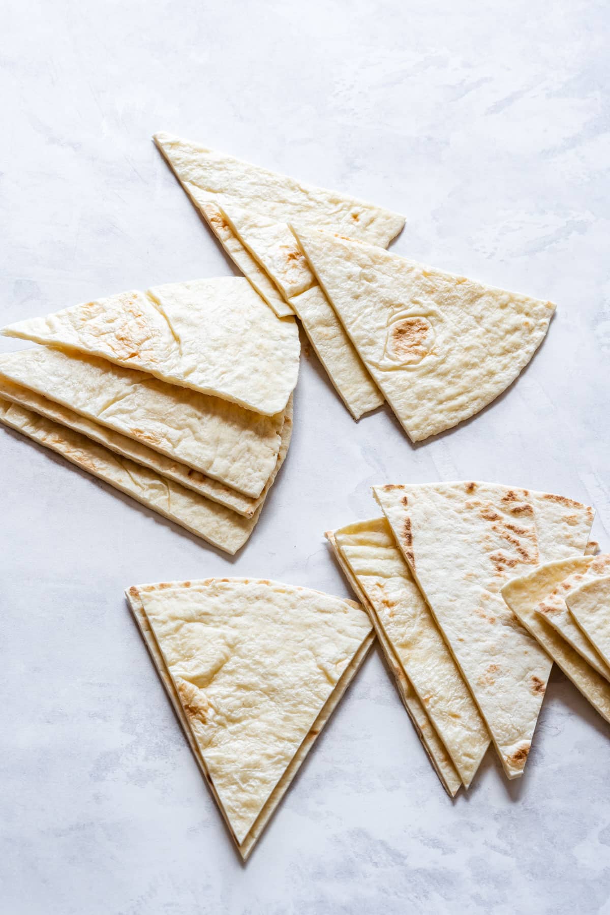 Flour tortilla cut into triangular shapes.