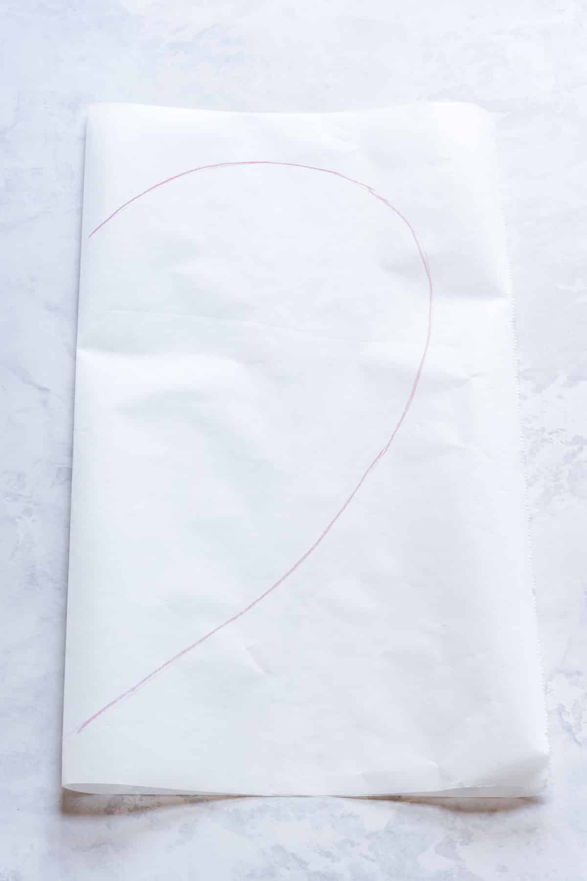 Hand-drawn red heart on a white parchment paper.