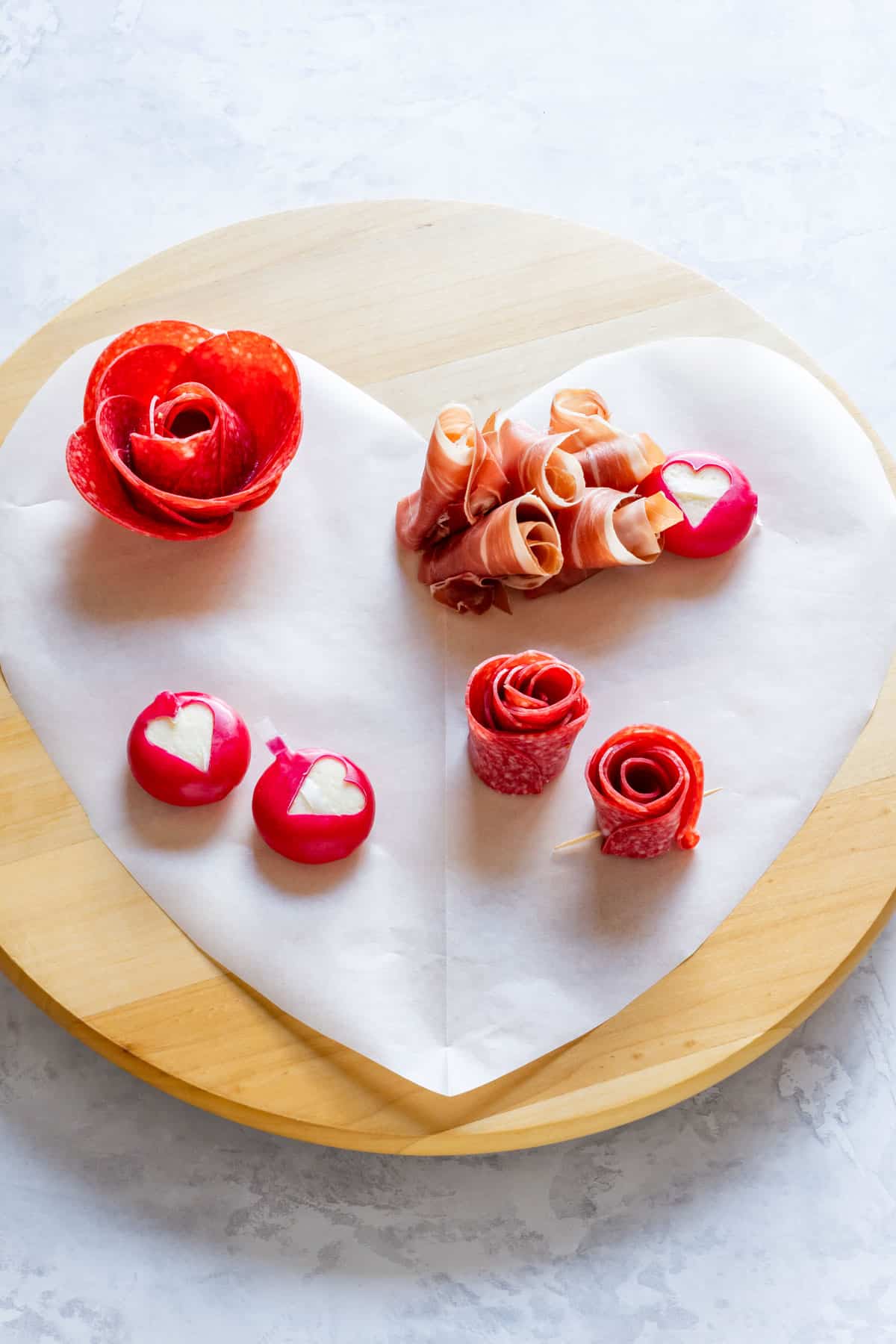 Showing how to start assembling the Valentine's Day charcuterie board.