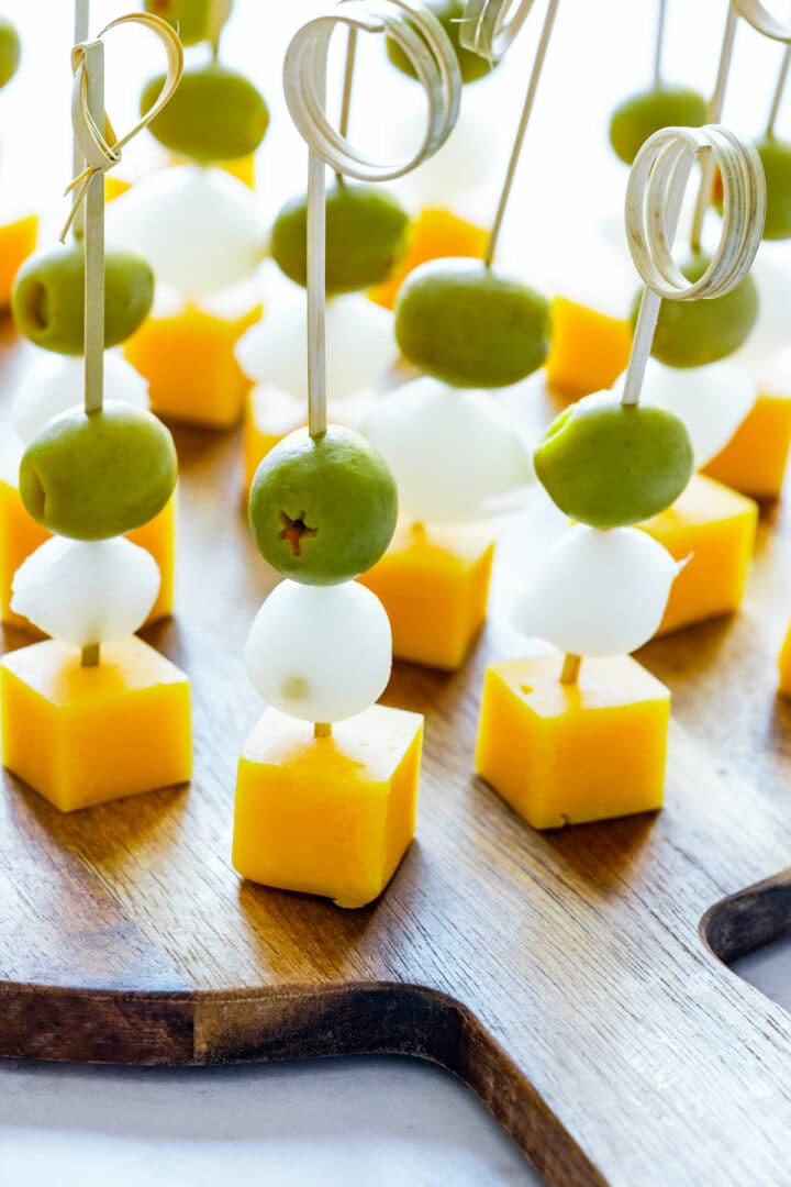 Close-up of festive skewers inspired by the Irish flag, arranged on a wooden serving board with decorative picks for an eye-catching party snack.